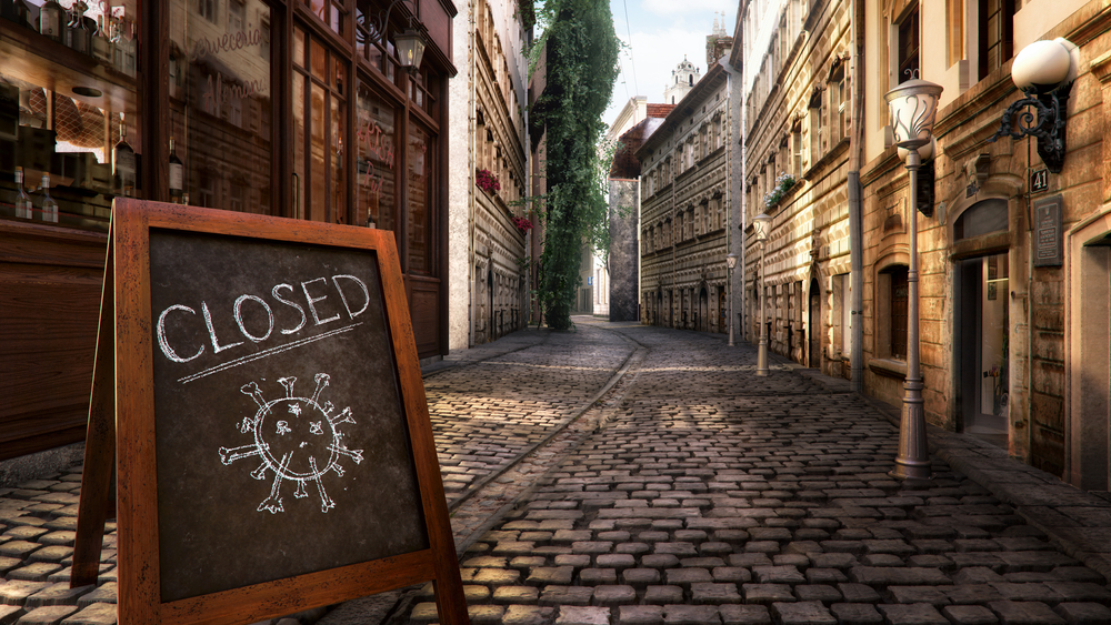 Picture of a closed sign on a street in Europe due to COVID.